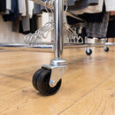 50mm twin wheel bolt hole castor fitted to a chrome clothes rail in a boutique