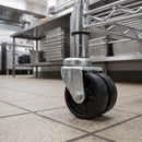 50mm twin wheel bolt hole castor under a chrome wire catering rack in a commercial kitchen