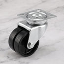 50mm twin wheel swivel top plate castor with black polypropylene wheels on light grey marble, high-angle three-quarter view