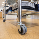 50mm twin wheel grey rubber bolt hole castor fitted to the chrome tube leg of a retail clothing display stand