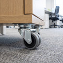 50mm twin wheel grey rubber top plate castor screwed under an oak mobile office desk pedestal