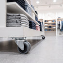 50mm twin wheel grey rubber top plate castor fitted under a white retail shop display unit