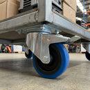 160mm braked top plate castor with blue non-marking rubber wheel bolted under a galvanised roll cage trolley