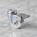 75mm braked swivel bolt hole castor with white nylon wheel, high angle view on light grey marble