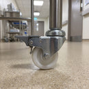 75mm braked white nylon castor fitted to a medical trolley