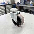 75mm grey rubber swivel castor on a workshop bench showing the M10 bolt hole