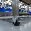 75mm twin wheel braked bolt hole castor fitted under the square tube leg of an assembly line workbench