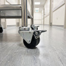 75mm twin wheel braked bolt hole castor fitted to the tube leg of a stainless steel hospital medical trolley