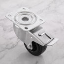 80mm braked swivel top plate castor black rubber wheel 70kg, high angle top-down view on grey marble