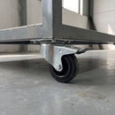 80mm braked top plate castor with black rubber wheel bolted under a grey steel workshop trolley