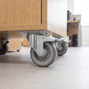 80mm braked top plate castor with grey TPR wheel fitted under an oak office storage pedestal on vinyl flooring