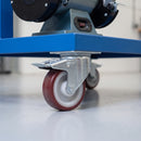 80mm braked top plate castor with maroon polyurethane wheel under a blue steel machine stand carrying a bench grinder