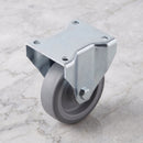 80mm fixed castor with grey TPR wheel and steel top plate on light grey marble, high angle view