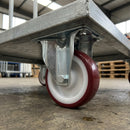 80mm fixed castor with red polyurethane wheel under a galvanised warehouse platform trolley