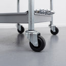 80mm black rubber swivel bolt hole castor fitted to a galvanised steel tool trolley leg in a workshop