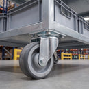 80mm swivel castor with grey polyurethane wheel under a warehouse trolley with tote bins