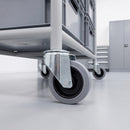 80mm grey rubber swivel bolt hole castor fitted to a steel container trolley leg