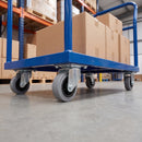 80mm swivel castors with grey rubber wheels bolted under a blue warehouse platform trolley loaded with boxes