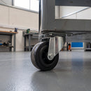 80mm swivel top plate castor with black rubber wheel under a grey steel workshop trolley