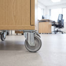 80mm swivel top plate castor with grey TPR wheel under an oak office storage pedestal on vinyl flooring