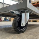160mm directional lock castor with black rubber wheel fitted under a galvanised platform trolley