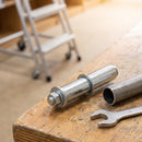 25.4mm spring fitting castor adaptor next to round steel tube and spanner, mobile library steps behind