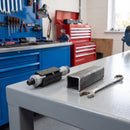 Square expanding castor tube adaptor next to a square steel tube and spanner on a workshop bench