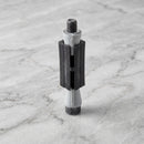 Square expanding tube adaptor 29-32mm for castors on light grey marble, high-angle three-quarter view